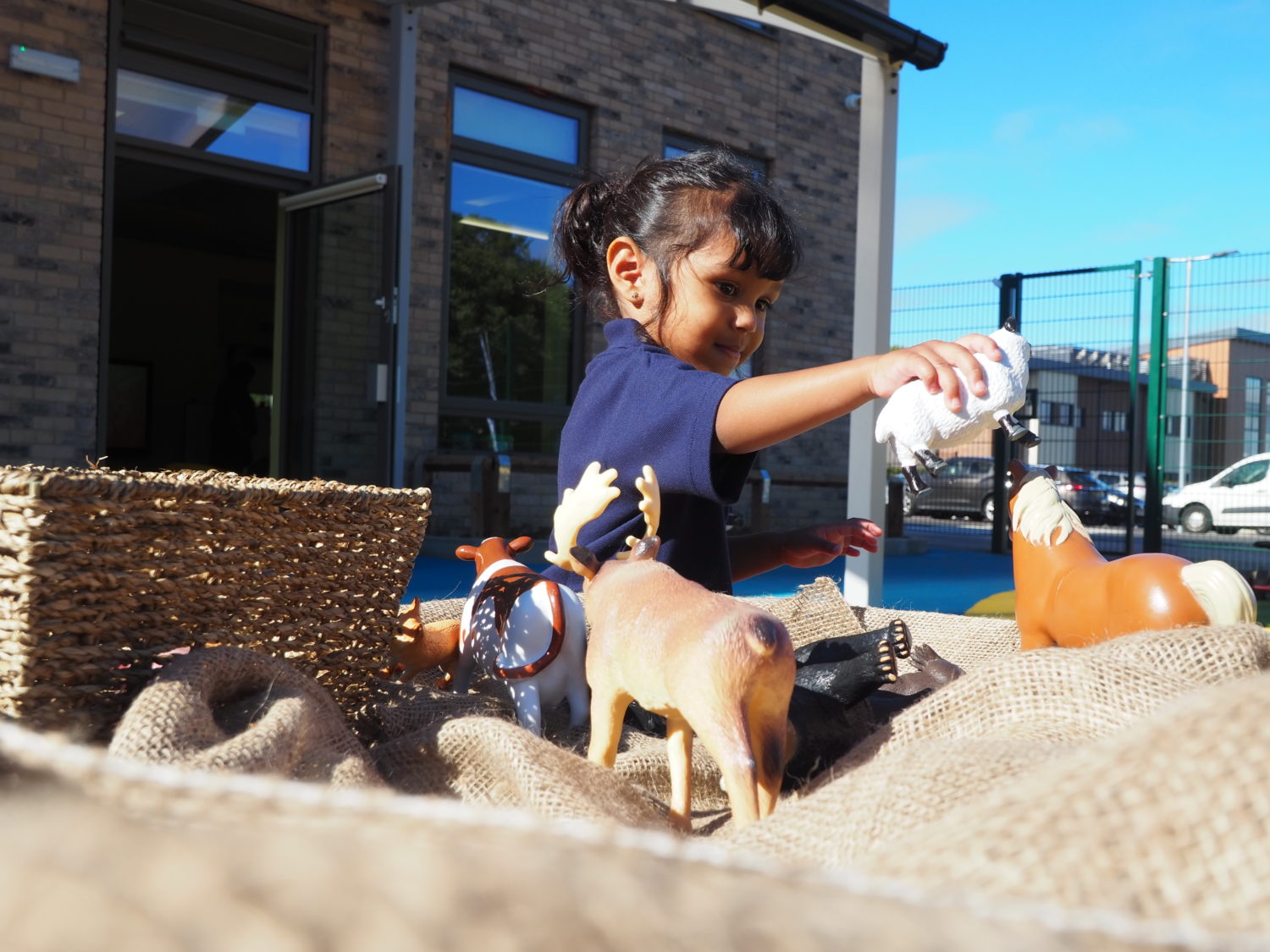 A child playing with animal toys