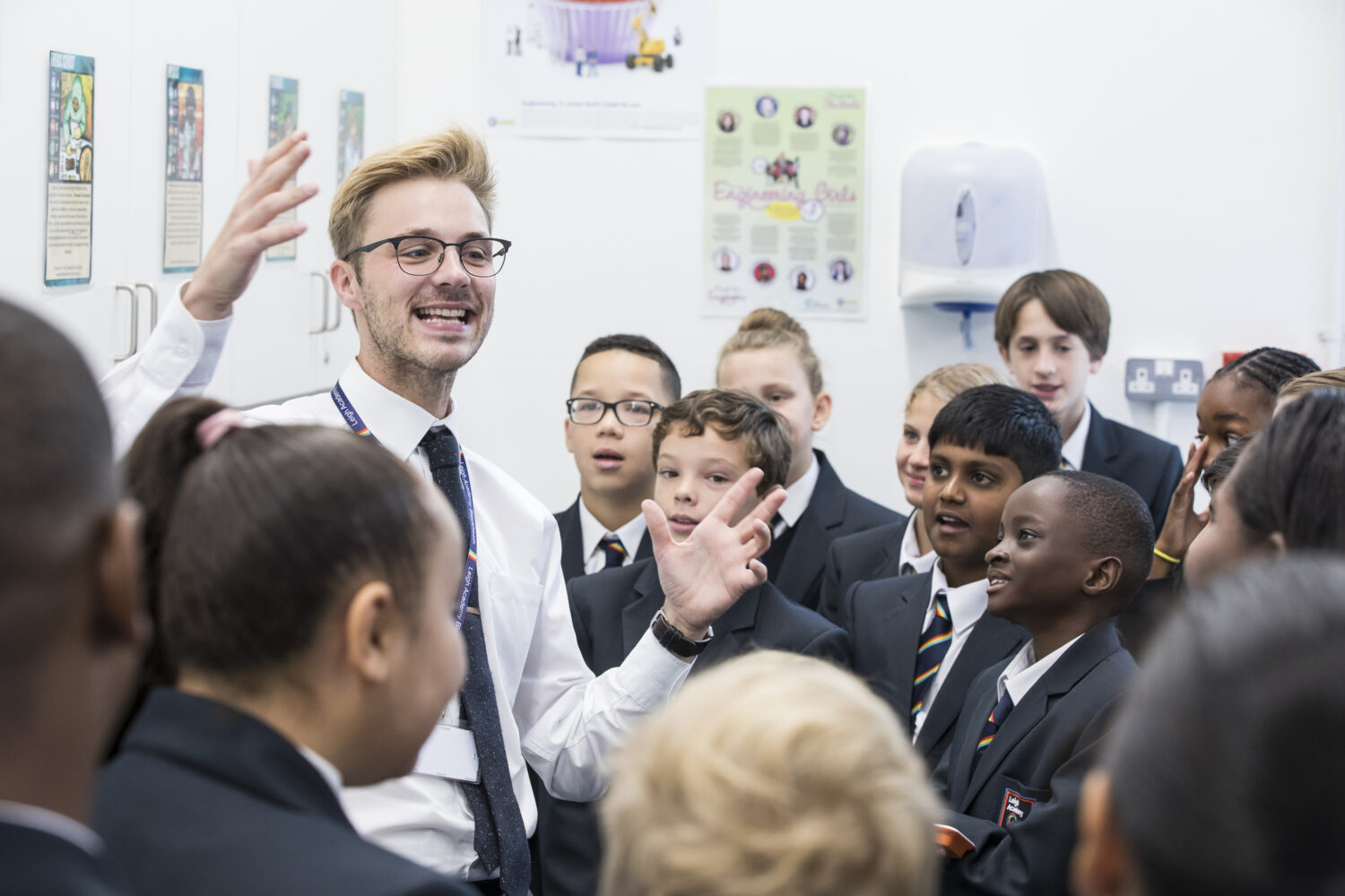 Staff member talking to students in a group.
